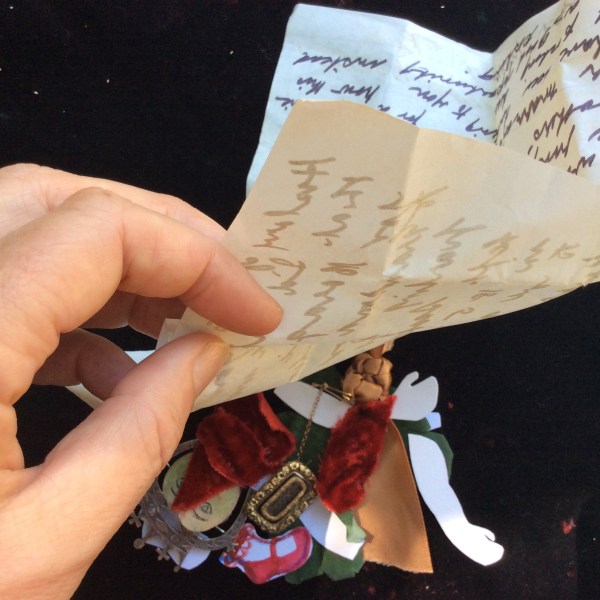 Puppet pieces, old letter and hand